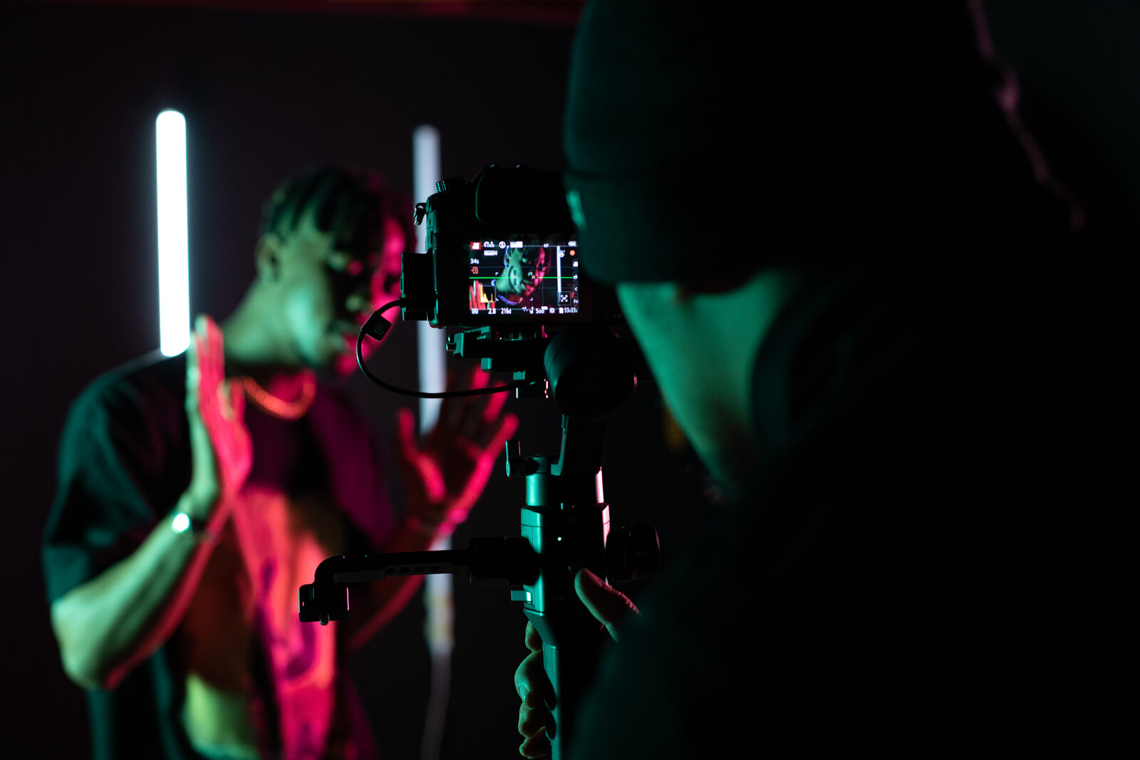 Dark set at Focus Studio — camera monitor and neon light