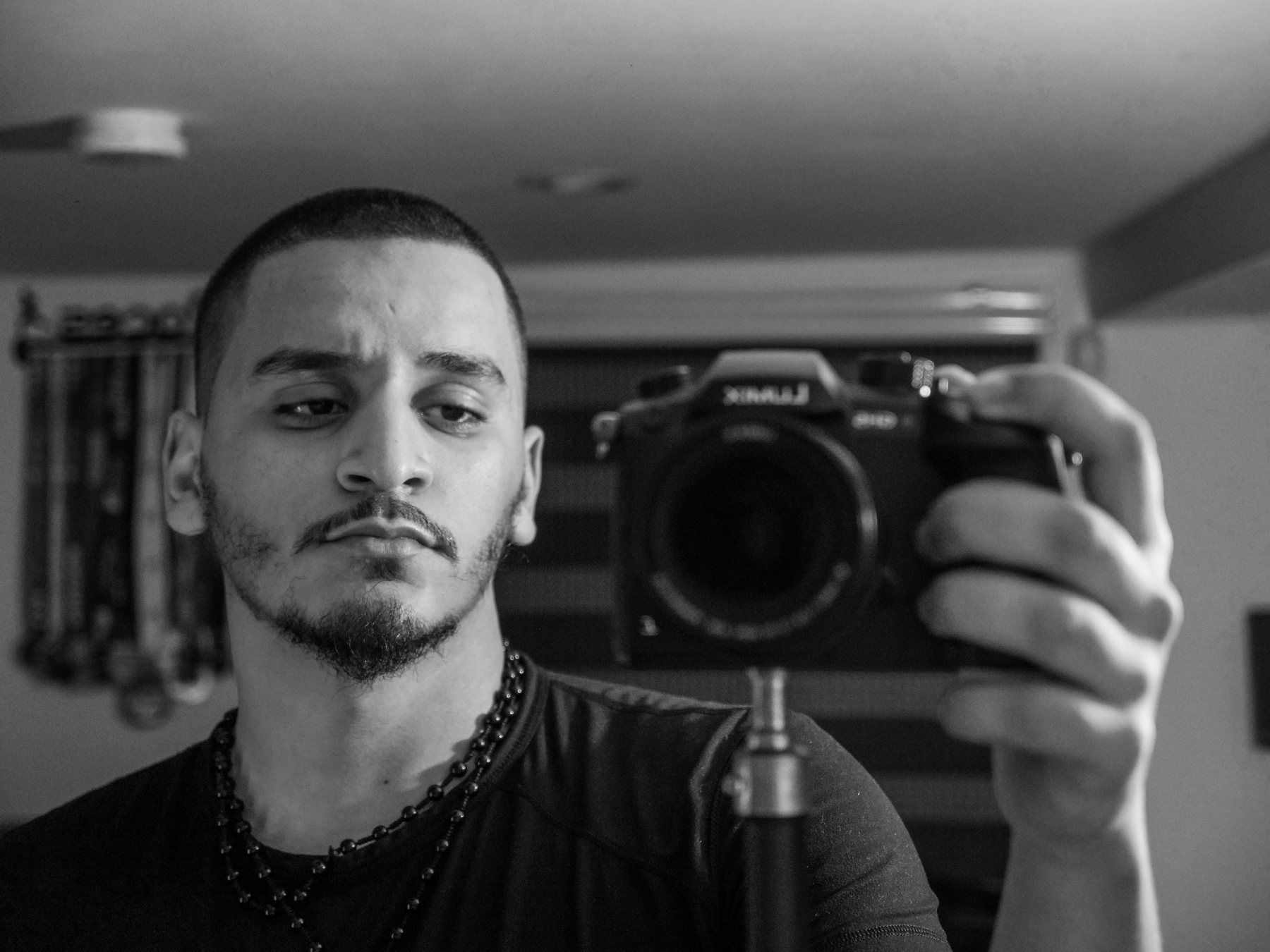 Early black and white self-portrait, camera in hand